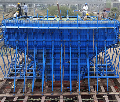 Blue pier-cap formwork system at a construction site